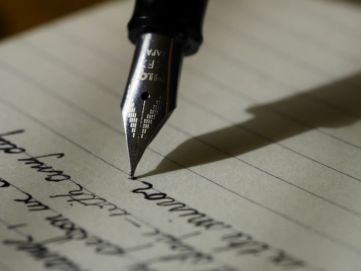A fountain pen mid-stroke on handwritten paper, the moment a founder commits to a structure.