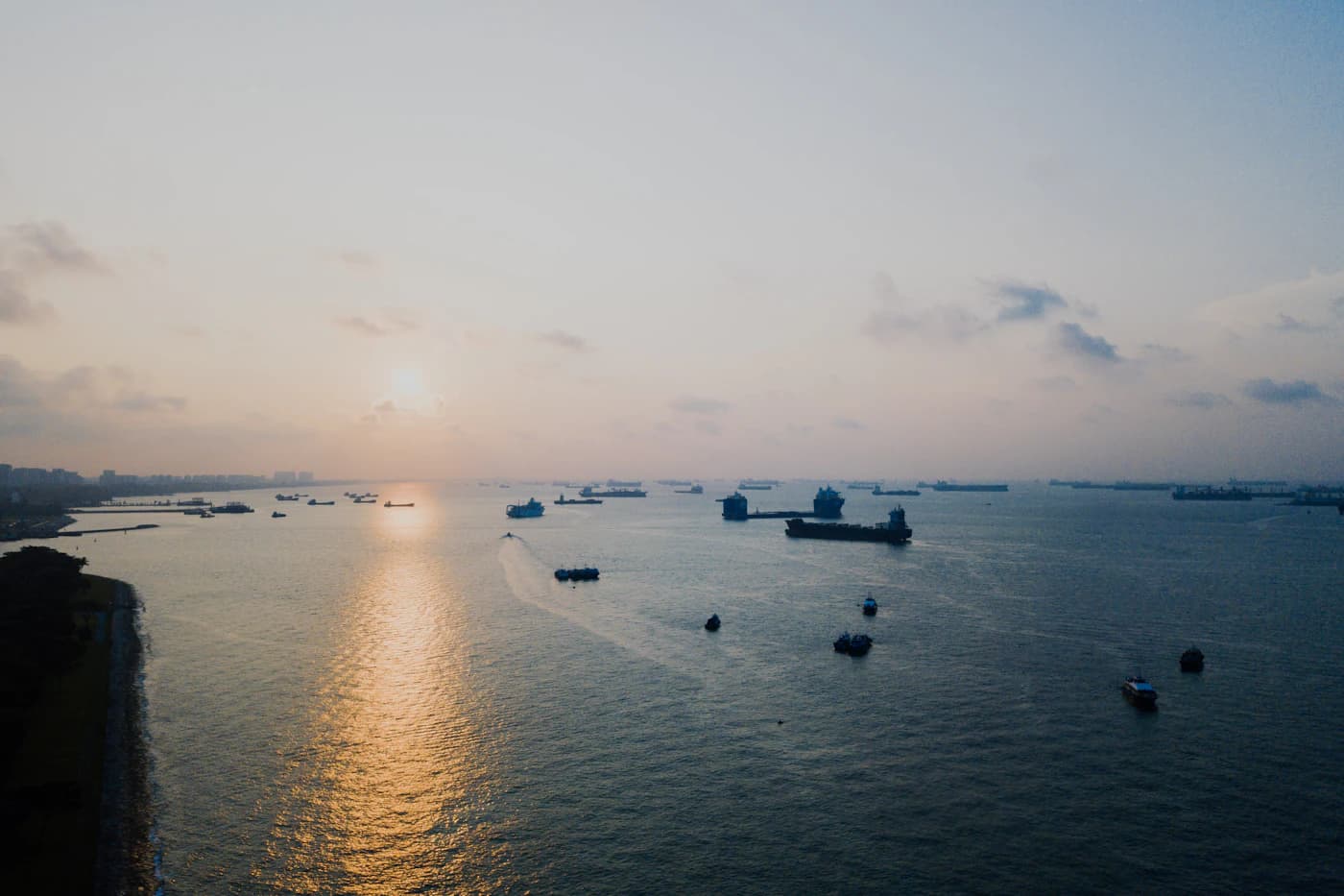 Ships on a calm sea at first light.