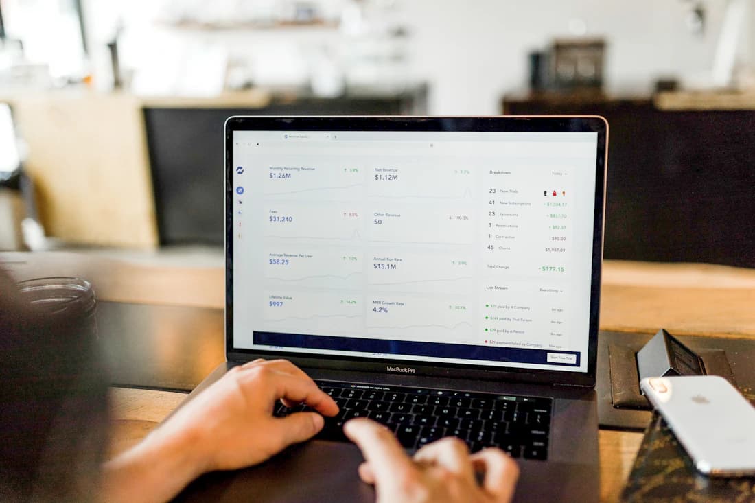 Hands at a laptop reviewing a seller sales dashboard.