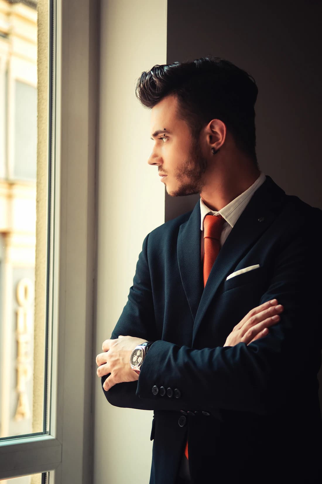 A founder at a window, considering a decision.