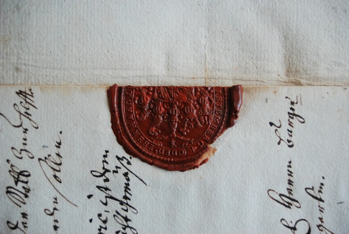 A red wax seal pressed onto a handwritten official document.