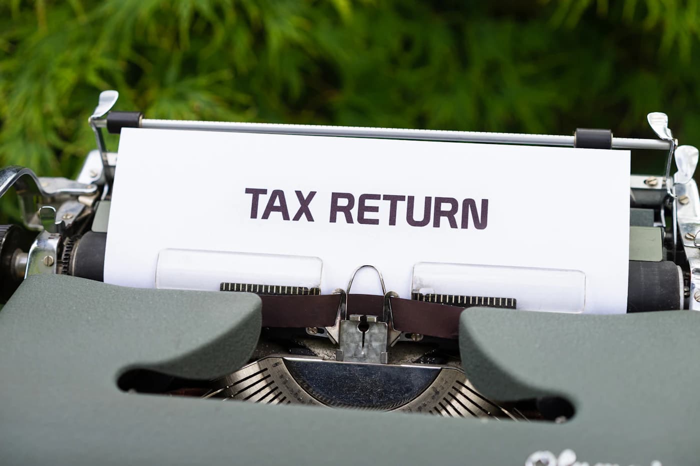 A person reviewing tax documents at a desk, the moment when an ITIN becomes necessary.