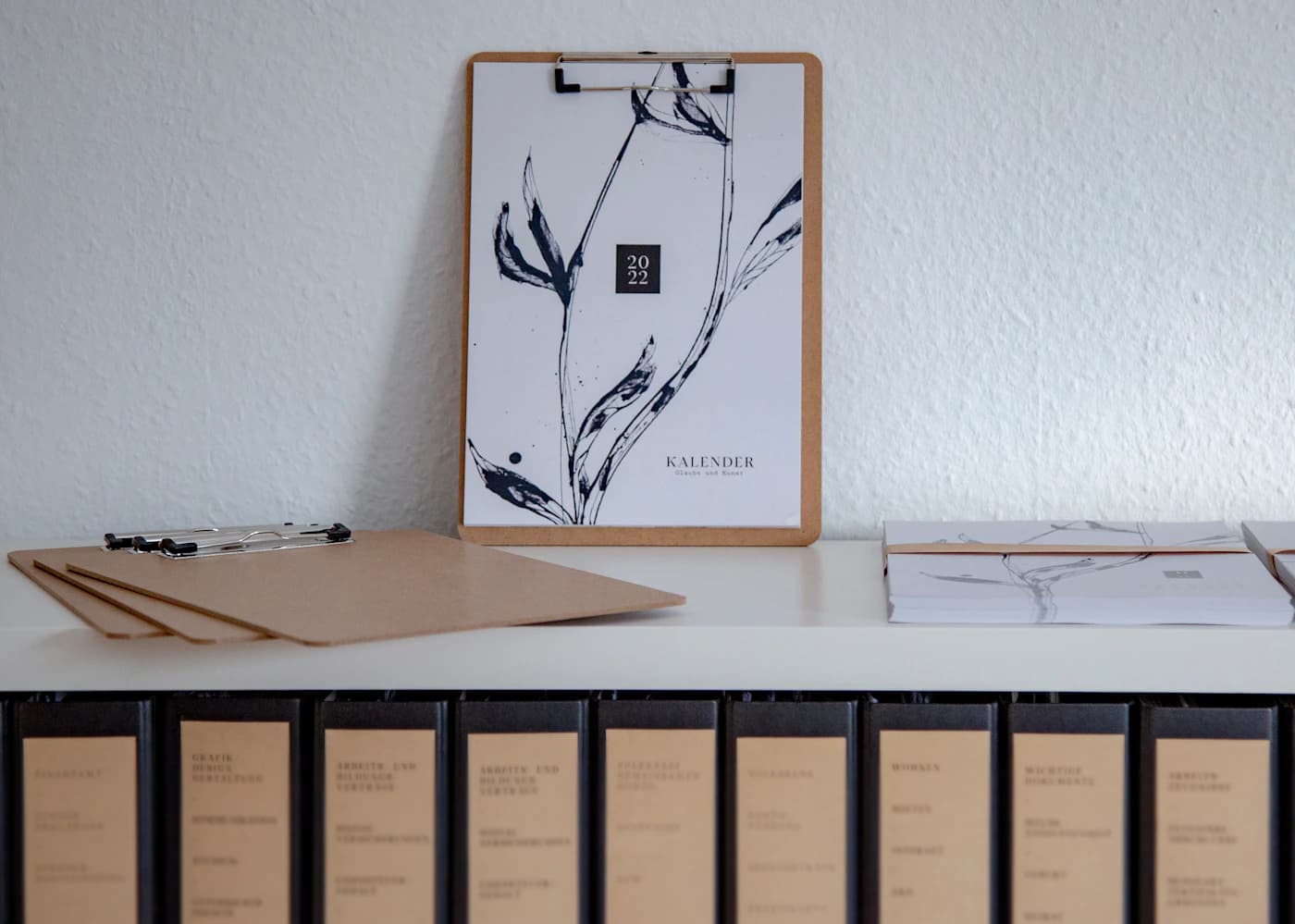 A closed leather folder on a desk, the moment after the final document has been signed.
