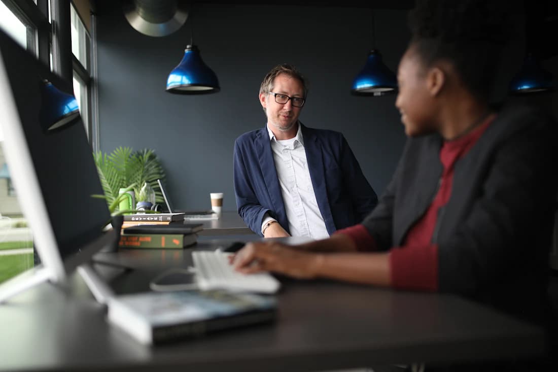 An advisor across the desk from a client, the consultation itself.