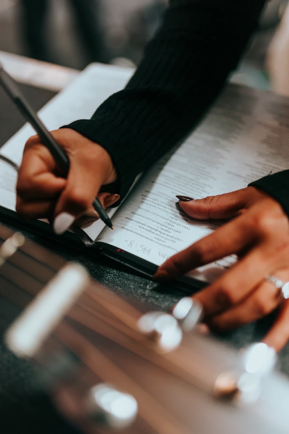 Hands completing an official document, every field confirmed.