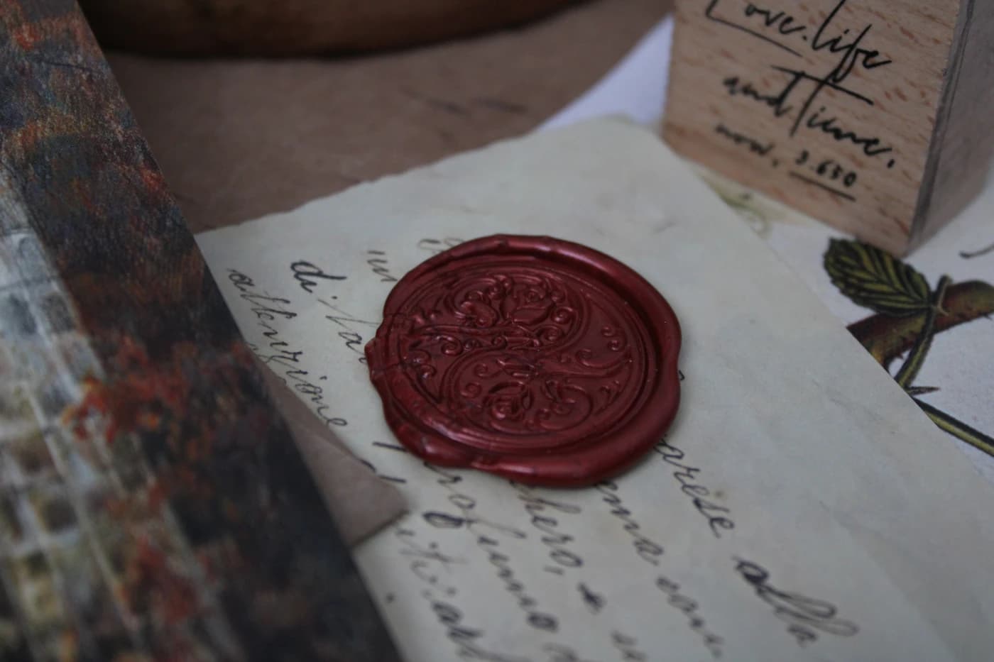 A red wax seal on an aged letter.