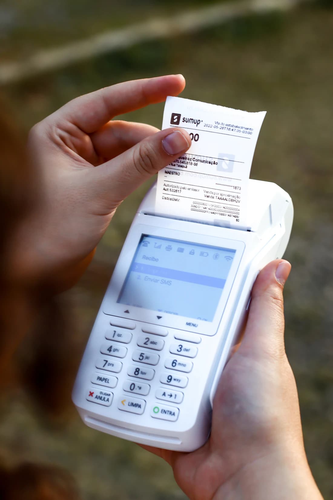 A card terminal printing a receipt at the point of sale.