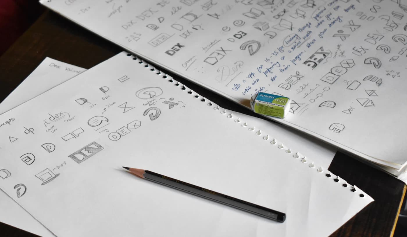 A pencil sketching the early version of a brand mark.