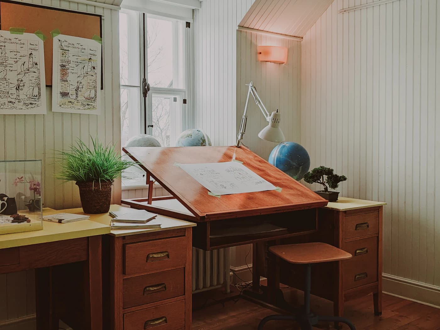A drafting table in a warm studio.