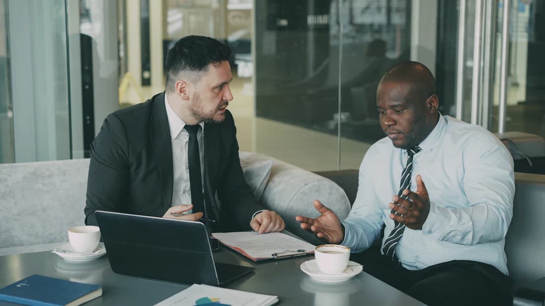 Two bankers reviewing an application, the moment the bank decides.